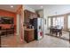Kitchen area with stainless steel refrigerator and dark wood cabinets that leads into dining area at 16712 S 175Th Ln, Goodyear, AZ 85338