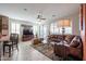 Living room with large leather sofa and a ceiling fan at 16712 S 175Th Ln, Goodyear, AZ 85338