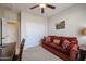 Cozy office space with a comfortable sofa, ceiling fan and convenient closet at 16712 S 175Th Ln, Goodyear, AZ 85338