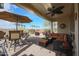 Inviting covered patio complete with outdoor furniture and a ceiling fan at 16712 S 175Th Ln, Goodyear, AZ 85338
