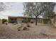Spacious backyard with desert landscaping, rock features, and outdoor living space at 17662 W Cedarwood Ln, Goodyear, AZ 85338