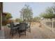 Backyard with paved patio, outdoor seating area, and desert landscaping at 17662 W Cedarwood Ln, Goodyear, AZ 85338