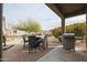 Backyard patio with BBQ and outdoor seating at 17662 W Cedarwood Ln, Goodyear, AZ 85338