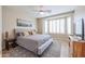 Bedroom featuring a fabric bed, a ceiling fan, plantation shutters, and natural light at 17662 W Cedarwood Ln, Goodyear, AZ 85338