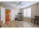 Bedroom featuring a ceiling fan, plantation shutters and a work station at 17662 W Cedarwood Ln, Goodyear, AZ 85338