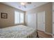 Bedroom featuring a ceiling fan, plantation shutters and a sliding door closet at 17662 W Cedarwood Ln, Goodyear, AZ 85338