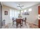 Dining area featuring a modern ceiling fan, shutters, and natural light at 17662 W Cedarwood Ln, Goodyear, AZ 85338