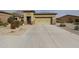 Charming single-story home with a spacious driveway and low-maintenance desert landscaping at 17662 W Cedarwood Ln, Goodyear, AZ 85338