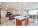 Open-concept area featuring an island with stainless steel dishwasher, living room, and dining area at 17662 W Cedarwood Ln, Goodyear, AZ 85338