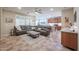 Bright and airy living room with a large sectional sofa and stylish décor at 17662 W Cedarwood Ln, Goodyear, AZ 85338