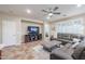 Cozy living room with a large sectional sofa, TV, and neutral color palette at 17662 W Cedarwood Ln, Goodyear, AZ 85338