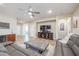 Spacious living room with a large sectional sofa, TV, and open floor plan at 17662 W Cedarwood Ln, Goodyear, AZ 85338