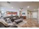 Open concept living space featuring a large sectional sofa, and a view of the kitchen at 17662 W Cedarwood Ln, Goodyear, AZ 85338