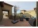 Relaxing patio space with a brick floor and a large umbrella for shade at 17662 W Cedarwood Ln, Goodyear, AZ 85338