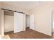 Bright bedroom showcases a closet, wood floors, and neutral wall tones with bright white trim at 2012 W Lawrence Rd, Phoenix, AZ 85015