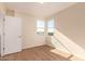 Empty bedroom with bright natural light, wood floors, and neutral wall colors at 2012 W Lawrence Rd, Phoenix, AZ 85015