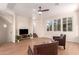 Cozy living room featuring hardwood floors, ceiling fan, and natural light from large windows at 2012 W Lawrence Rd, Phoenix, AZ 85015