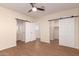 Spacious main bedroom boasts hardwood floors, modern ceiling fan and ensuite bathroom with closet at 2012 W Lawrence Rd, Phoenix, AZ 85015