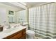 Bright bathroom featuring single sink, wood cabinet, mirror, and neutral paint at 20215 N Medallion Ct, Sun City West, AZ 85375