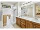 Bright bathroom featuring a double sink vanity and walk-in shower with a glass door at 20215 N Medallion Ct, Sun City West, AZ 85375