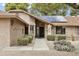 Inviting front entrance with desert landscape, solar panels and a walkway leading to the front door at 20215 N Medallion Ct, Sun City West, AZ 85375