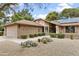 Beautiful front exterior with well-kept lawn, gravel accents, solar panels, and a two-car garage at 20215 N Medallion Ct, Sun City West, AZ 85375
