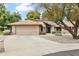Charming single-story home featuring a well-maintained yard, two car garage and desert landscaping in front at 20215 N Medallion Ct, Sun City West, AZ 85375