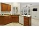 Bright kitchen with wood cabinets, granite countertops, stainless steel appliances, and tile floors at 20215 N Medallion Ct, Sun City West, AZ 85375