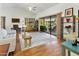 Bright living room with a ceiling fan, hardwood floors, neutral furnishings and sliding door access to the backyard at 20215 N Medallion Ct, Sun City West, AZ 85375