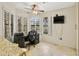 Bright office space with large window, dark desk, and neutral tile floors at 20215 N Medallion Ct, Sun City West, AZ 85375