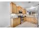 Well-lit kitchen with wood cabinets, stainless steel appliances, and tiled backsplash at 30428 N Saddlebag Ln, San Tan Valley, AZ 85143