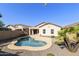 Private backyard with refreshing pool, lush landscaping, and patio area for outdoor enjoyment at 41201 N Stenson Dr, San Tan Valley, AZ 85140