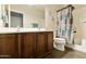 Bathroom with double sink vanity, tile floor and shower-tub combo with shower curtain at 41201 N Stenson Dr, San Tan Valley, AZ 85140