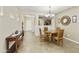 Elegant dining room with stylish chandelier, neutral tones, and tile flooring for a sophisticated dining experience at 41201 N Stenson Dr, San Tan Valley, AZ 85140