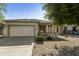 Inviting single-story home with a spacious driveway and well-kept landscaping for a welcoming curb appeal at 41201 N Stenson Dr, San Tan Valley, AZ 85140