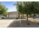 Charming single-story home with a well-maintained lawn, mature trees, and a two-car garage for comfort and convenience at 41201 N Stenson Dr, San Tan Valley, AZ 85140