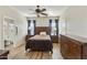 Relaxing main bedroom featuring neutral walls, a ceiling fan, and wood-look floors, creating a serene atmosphere at 41201 N Stenson Dr, San Tan Valley, AZ 85140