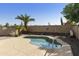Inviting backyard pool with a tanning deck and patio area, perfect for relaxation and enjoying sunny days with privacy wall at 41201 N Stenson Dr, San Tan Valley, AZ 85140