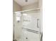 Modern shower with glass doors, chrome fixtures, and a built-in shelf for bath essentials at 41201 N Stenson Dr, San Tan Valley, AZ 85140