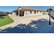 A spacious backyard features a large patio, artificial turf, and desert landscaping at 5255 W Cochise Dr, Glendale, AZ 85302