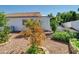 A view of a spacious backyard with lush greenery and desert landscaping at 5255 W Cochise Dr, Glendale, AZ 85302