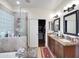 Bright bathroom featuring a separate tub and shower, and double vanity with granite counters at 5255 W Cochise Dr, Glendale, AZ 85302