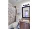 Bathroom featuring a shower with floral curtain, toilet, and vanity with granite counters and dark brown cabinets at 5255 W Cochise Dr, Glendale, AZ 85302