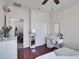 A bedroom featuring wood flooring, a built in vanity and a mirror at 5255 W Cochise Dr, Glendale, AZ 85302
