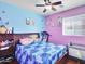Inviting bedroom features an accent wall and wood floors, filled with decorations at 5255 W Cochise Dr, Glendale, AZ 85302