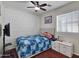 This bedroom features a decorative wall, ceiling fan, and modern furnishings at 5255 W Cochise Dr, Glendale, AZ 85302