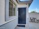 Side view of the home with a metal security door and small area for seating at 5255 W Cochise Dr, Glendale, AZ 85302