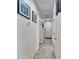 Well-lit hallway with neutral walls and tile flooring, featuring multiple entryways at 5255 W Cochise Dr, Glendale, AZ 85302
