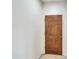 Entry way into the home with tile floors and a wooden door at 5255 W Cochise Dr, Glendale, AZ 85302