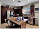 Modern kitchen featuring dark wood cabinets, stainless steel appliances, and granite island with seating at 5255 W Cochise Dr, Glendale, AZ 85302